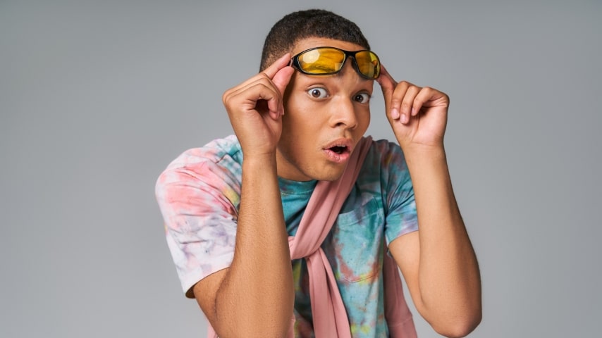 A man wearing a colorful sublimation shirt in pastel tones.