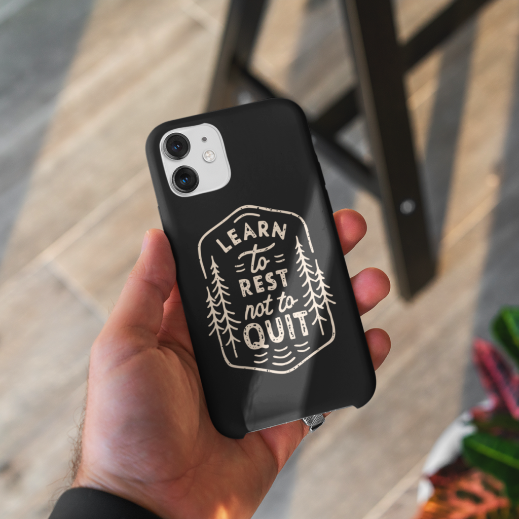A custom black phone case with a “Learn to rest not to quit” print with illustrations.